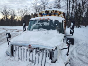Snow-covered bus on a winter day.
